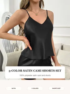 Close-up of a women's black satin cami and shorts sleepwear set in 100% polyester
