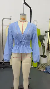 Light blue deep V-neck blouse with cinched drawstring waist and delicate lace hollow details