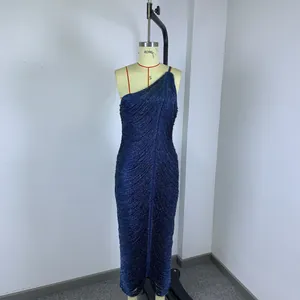Detailed view of shimmering navy blue fringe tassels on a one-shoulder bandage party dress.