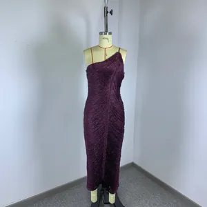 Detail view of a purple one-shoulder sparkling bandage dress with fringe texture.
