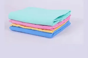 Stacked colorful synthetic chamois pet towels in mint green, pink, yellow, and blue