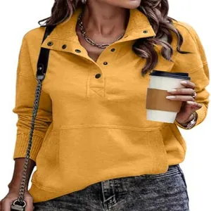 Close-up of women's casual mustard yellow sweatshirt with button stand collar detail.