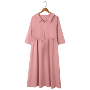 Close-up of a pink cotton linen midi dress with a classic collar and button details.