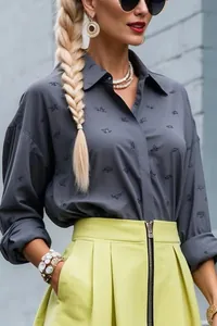 Detail of a grey printed commuter shirt paired with a lime green zippered skirt