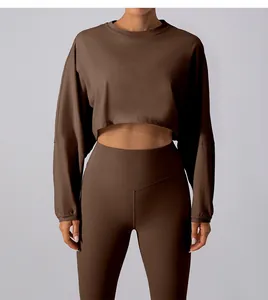 Front view detail of brown cropped sports sweatshirt and high waist yoga leggings