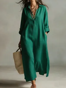 Elegant green linen maxi shirt dress with lapel collar, side slits and handy pockets.