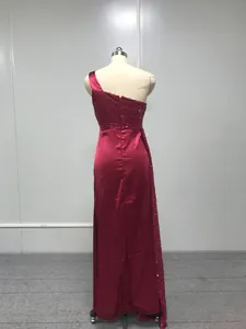 Detailed back view of an elegant red one-shoulder mermaid evening dress with sequins