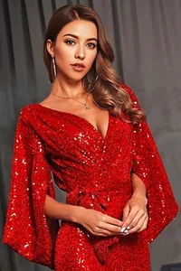 Detailed shot of vibrant red sequined evening gown with elegant V-neckline and tie waist