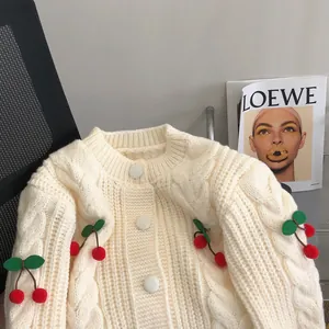 Sweet cream cable knit cardigan featuring cute cherry pom-pom decorations for women