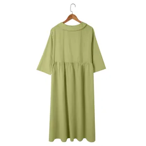 Back view of a casual light green cotton linen midi dress with a pleated waistline