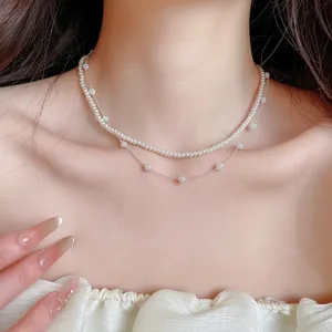 Close-up of a double-layered vintage French pearl and crystal ball necklace on a model's neck