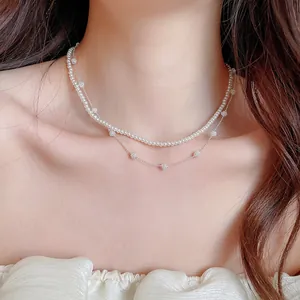Elegant double-layer necklace with white pearls and sparkling silver rhinestone balls