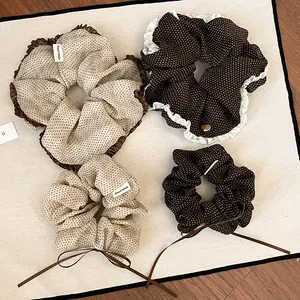 Detailed view of various retro polka dot scrunchies with elegant lace and ribbon bows