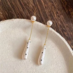 Elegant vintage water-drop pearl earrings with gold chain and chic polka dot accents