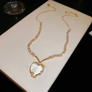 Elegante goudkleurige luxe halsketting met een grote fonkelende hartvormige zirkonia hanger