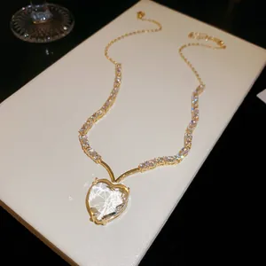 Close-up van vintage gouden ketting met een briljante hartvormige zirkoon hanger