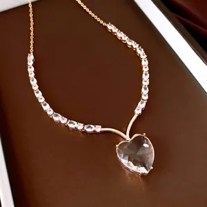 Elegant gold-plated necklace featuring a large heart-shaped crystal pendant detail