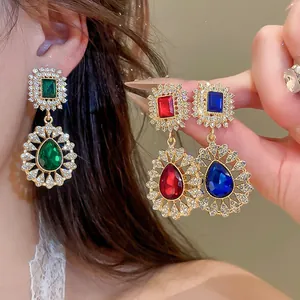 Close-up of vintage court earrings with colorful teardrop crystal pendants and diamonds