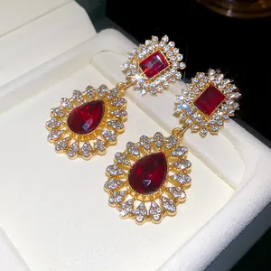 Detailed macro view of vintage palace style red stone drop earrings with crystals