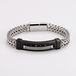 Close-up detail of stainless steel wheat chain bracelet with black curved plate design