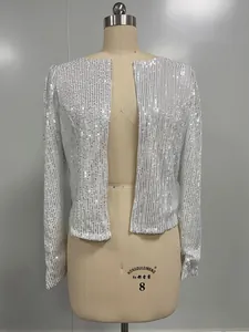 Macro detail view of shimmering white sequined long sleeve cropped jacket on mannequin