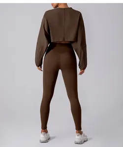 Back view of brown cropped long-sleeve sports top and matching high-waisted leggings