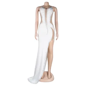 Detailed view of white evening dress with shimmering rhinestones, mesh panels and high side slit