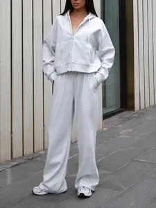 Women's two-piece grey tracksuit set with zip-up hoodie and wide-leg sweatpants