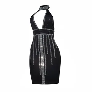 Close-up of a sexy black halter dress featuring sparkling rhinestone fringe and a bodycon fit.