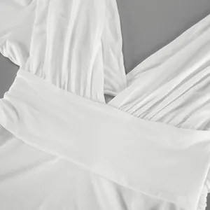 Primer plano de top blanco de modal con cuello en V, elegantes pliegues y textura suave.