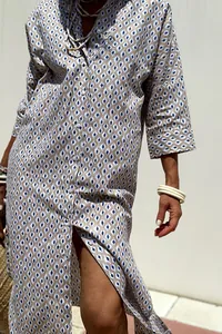 Close-up view of geometric patterned shirt dress with button-up detail and lapels.