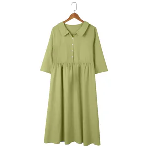 Close-up of a women's olive green cotton linen dress with Peter Pan collar and buttons