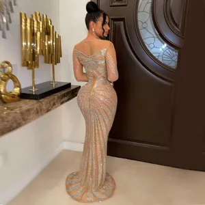 Back view of elegant nude mesh dress featuring sparkling silver rhinestone patterns