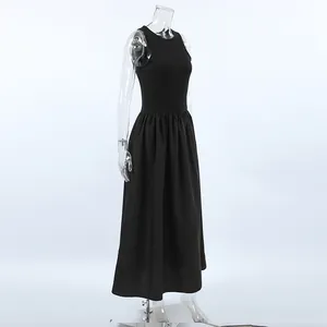 Side profile of a retro black sleeveless maxi dress displayed on a clear mannequin