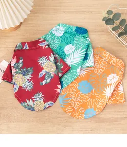 Detailed view of three colorful Hawaiian print dog shirts in red, teal, and orange styles