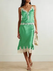 Full-body view of elegant green satin camisole and midi skirt set with white lace trim