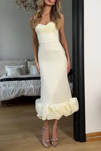 Full length detail of elegant white slim fit mermaid dress with dramatic ruffled hem