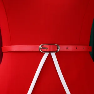 Close-up of a red professional pencil dress waist with a thin belt and silver buckle
