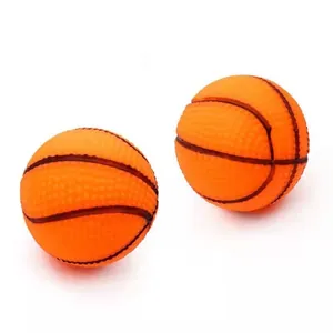 Close-up of two orange basketball-shaped squeaky dog toys with a durable textured surface