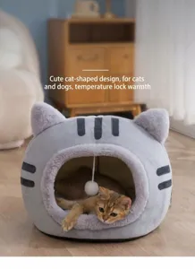 Close-up of semi-enclosed cat head shaped plush bed with kitten sleeping inside