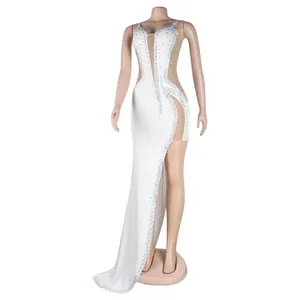 Full view of a sexy white evening gown with sparkling rhinestones and mesh panels.