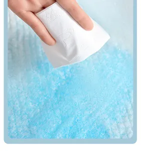 Close-up of absorbent pet pee pad surface demonstrating dryness with a tissue