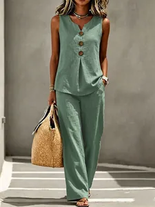 Model wearing sage green linen two-piece set with V-neck button top and wide-leg pants