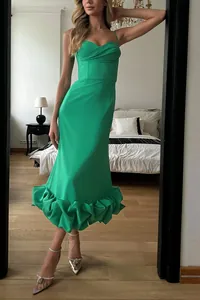 Elegant green sleeveless midi dress with ruffled hem and bustier top for evening events.