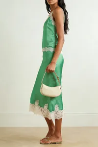 Close-up side view of a green satin two-piece loungewear set with delicate lace trims