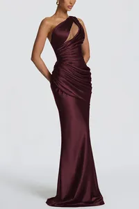 Detail view of an elegant burgundy satin one-shoulder mermaid dress with pleats.