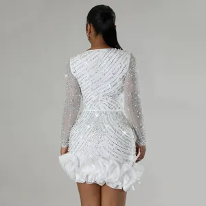 Back view of white long sleeve mini dress with sparkling rhinestones and pearl beads