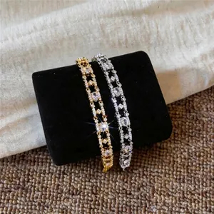 Elegant 18k gold plated zircon oval bracelets displayed on a black velvet cushion
