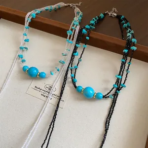 Detail shot of multi-layered turquoise stone necklaces with black and clear beads