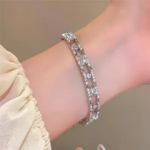 Detailed view of silver-toned oval bracelet with shimmering cubic zirconia inlay